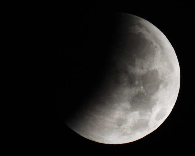 Partially shadowed moon at night