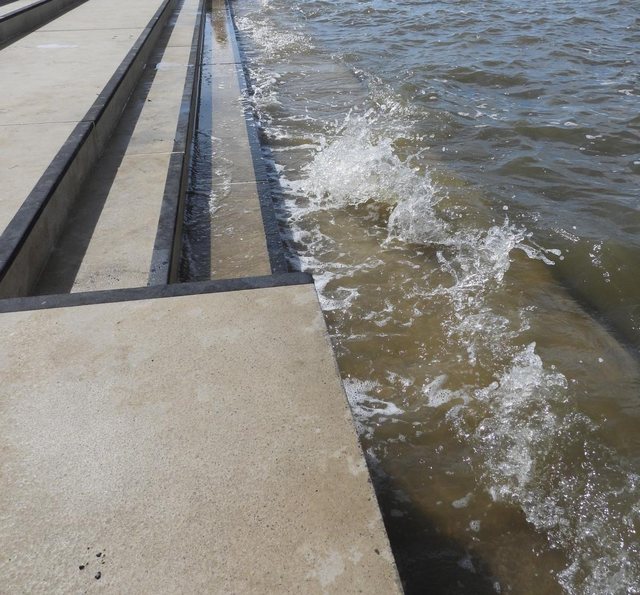 Wave breaking over a stone pier