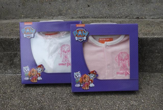 Two gift boxes with children’s clothing, product photo